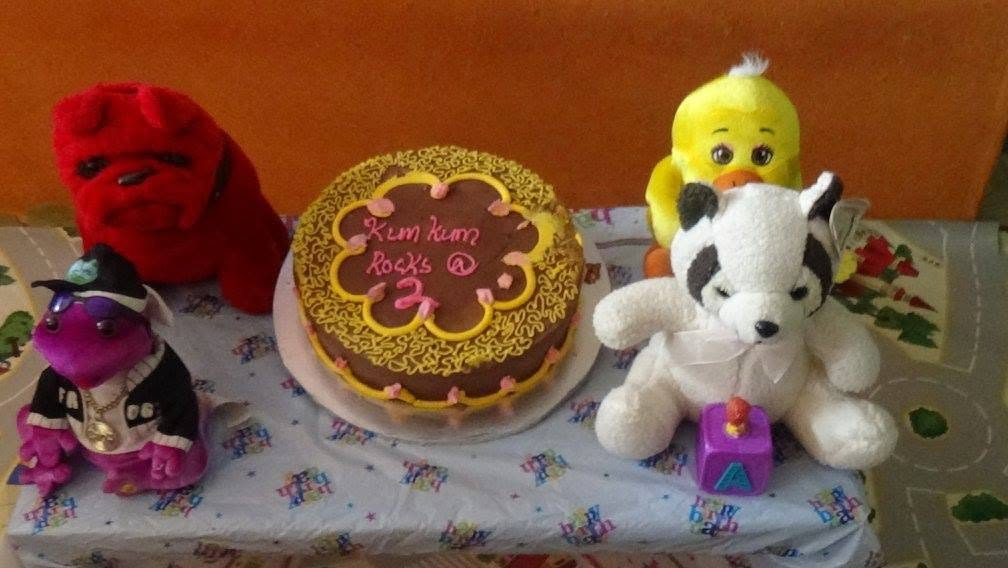 Birthday cake and soft toys at a Seraphic Kidz celebration